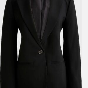 55% linen/45% cotton. Notch collar. Button closure. Welt pockets. Functional but